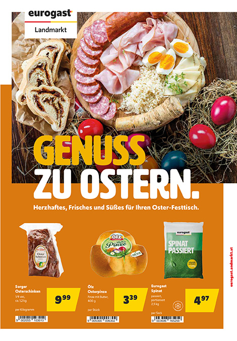 Werbeplakat zu Ostern: Auf einem Holztisch liegt eine rustikale Jausenplatte mit Wurst, Schinken, Käse, gekochten Eiern und Kren, daneben ein aufgeschnittenes Ostergebäck. Rundherum liegen bunt gefärbte Ostereier und Stroh. Großer Text: „Genuss zu Ostern. Herzhaftes, Frisches und Süßes für Ihren Oster-Festtisch.“ Darunter drei beworbene Produkte mit Preisen: Osterschinken, Osterpinze und passierter Spinat.
